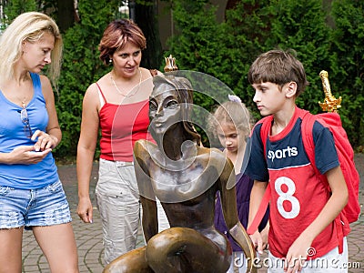 Tourists near the sculpture `The Frog Princess` in Svetlogorsk. Editorial Stock Photo