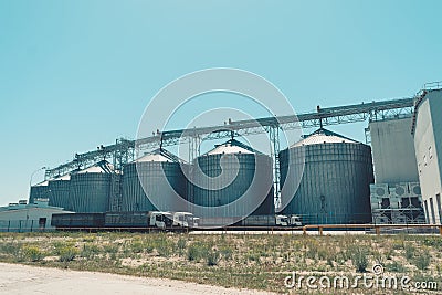 Svetlovodsk, Ukraine 27 May, 2018: Modern Agricultural Silos against blue sky. Storage and drying of grains, wheat, corn, soy Editorial Stock Photo