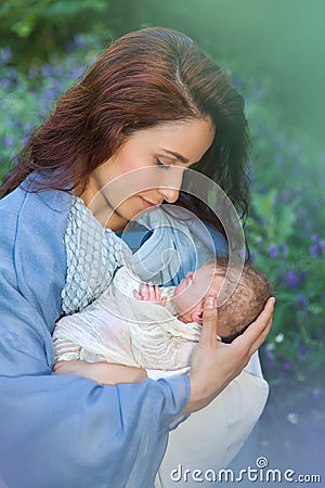 Swaddles baby Jesus in Mary`s hands Stock Photo