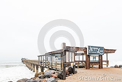 Historic jetty with restaurant on its far end in Swakopmund Editorial Stock Photo