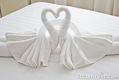 Swans made from towels on the bed. Stock Photo