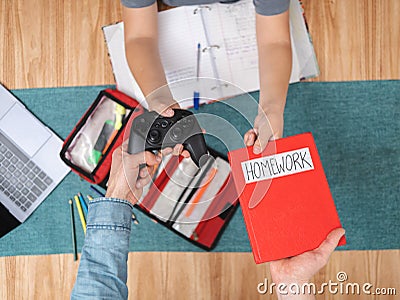 Swapping video games for homework. Back to school concept Stock Photo