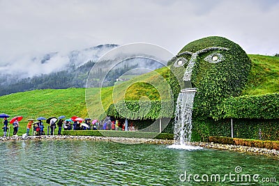 Swarovski Crystal Museum, a fountain in the form of a head covered with plants Editorial Stock Photo