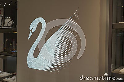 The Swarovski swan symbol and logo on a store front. Swarovski swan sign. Swarovski jewelry brand logo close up. Swarovski jewelry Editorial Stock Photo