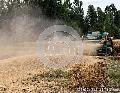 Swat, Pakistan - 24 May 2023: Wheat thresher processing and separating wheat from straw Editorial Stock Photo