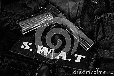 SWAT Special weapons and tactics team equipment with hand gun on black uniform background Editorial Stock Photo