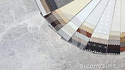 swatch of blackout curtain drapery fabric samples with different textures placed on stone marble table. Stock Photo