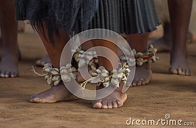 Bare feet of Swazi woman dancers with handmade rattles in Swaziland Editorial Stock Photo