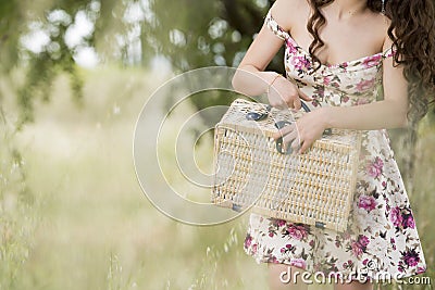 Sweat young woman holding a retro picnic basket Stock Photo