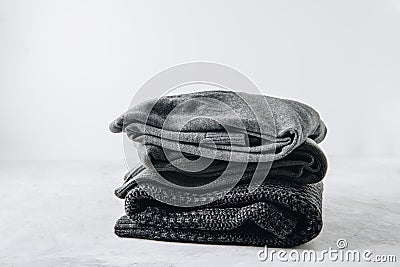 Sweaters. Black knitted sweaters on gray background Stock Photo