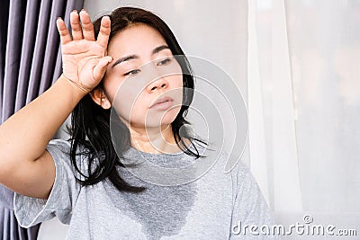 Sweating Asian woman in summer with hot weather Stock Photo