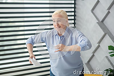 Standing adult woman with a napkin in hand. Stock Photo