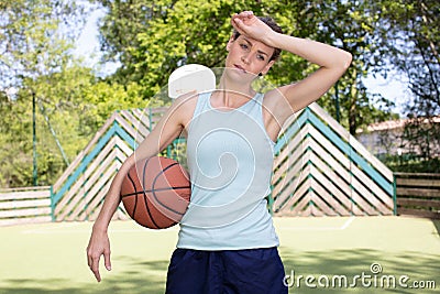 Sweaty female basketball player wiping brow Stock Photo