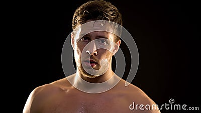 Sweaty male boxer hardly breathing after exhausted training, professional sport Stock Photo