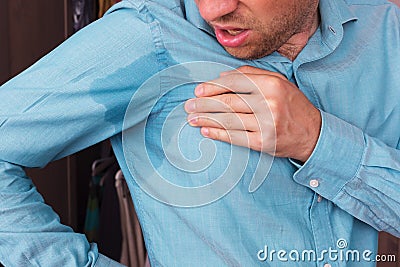Sweaty spot on the shirt because of the heat, worries and diffidence Stock Photo
