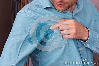 Sweaty spot on the shirt because of the heat, worries and diffidence Stock Photo