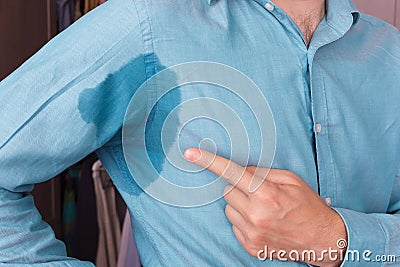 Sweaty spot on the shirt because of the heat, worries and diffidence Stock Photo