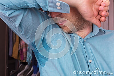 Sweaty spot on the shirt because of the heat, worries and diffidence Stock Photo