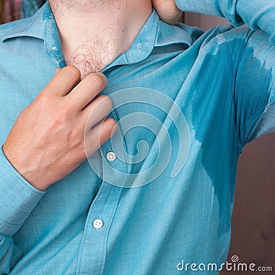 Sweaty spot on the shirt because of the heat, worries and diffidence Stock Photo