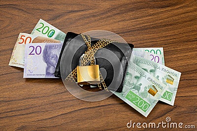 Swedish banknotes sticking out from a locked black wallet Stock Photo