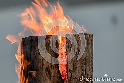 Swedish torch fire burning stub on plate for rest and for warming in winter Stock Photo