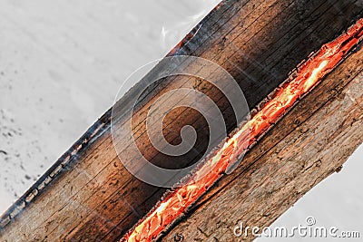 Swedish torch fire burning stub on plate for rest and for warming in winter Stock Photo