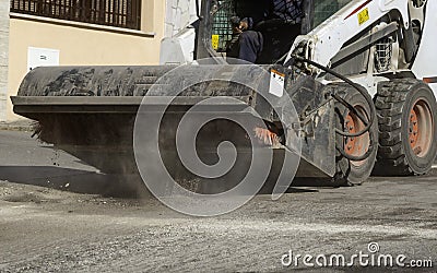 The sweeper sweeps, collects and dumps dirt and debris Stock Photo