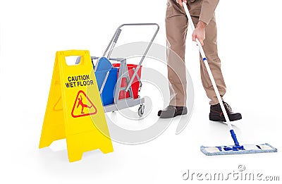 Sweeper cleaning floor with warning sign Stock Photo