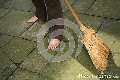 Sweeping with broomstick Stock Photo
