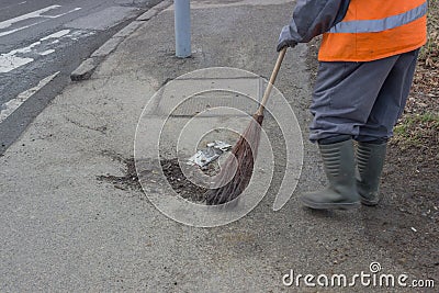 Sweeping and pushing a broom Stock Photo