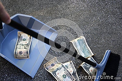 Sweeping up money Stock Photo