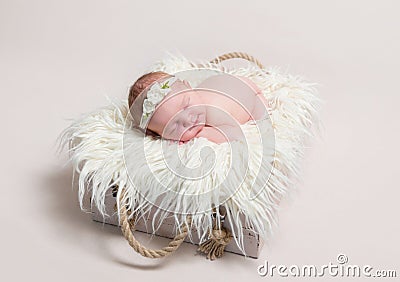 Sweet baby in hairband napping Stock Photo