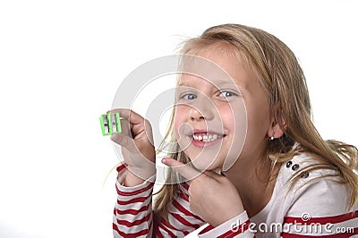 Sweet beautiful female child with blue eyes holding drawing pencil sharpener school supplies Stock Photo