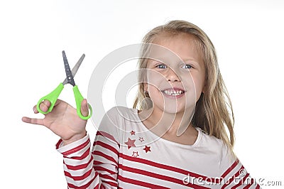 Sweet beautiful female child 6 to 8 years old holding cutting sc Stock Photo