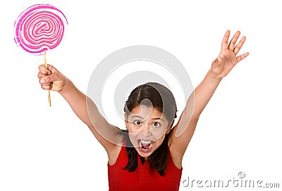 Sweet beautiful latin female child holding big pink spiral lollipop candy Stock Photo