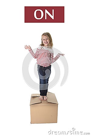 Sweet blond hair child stading on top of cardboard box isolated on white background in learning english Stock Photo