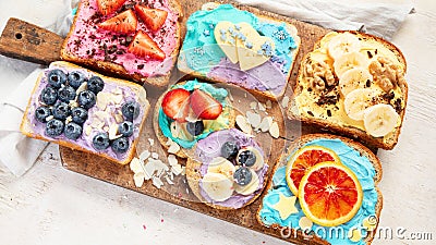 Sweet breakfast. Colorful toasts with fruits and berries. Children's food concept Stock Photo
