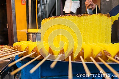 Sweet Brightly Colored Yellow Cake at Traditional Chinese Market Stock Photo