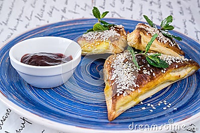 Sweet cakes triangular shape with sesame seeds and jam Stock Photo