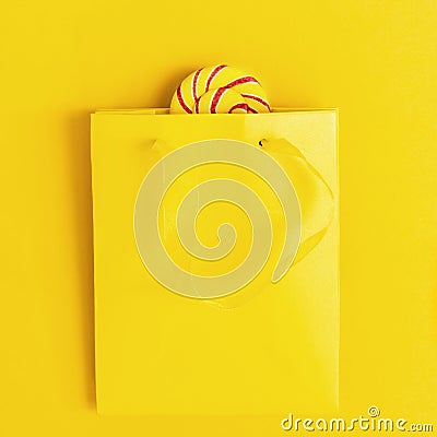 Sweet candy lollypop bright colored peeps out of yellow paper bag. Unhealthy food, concept Refusal of sweet Stock Photo