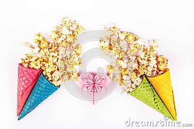 Sweet caramel popcorn and paper heart. Copy space. Origami heart of pink paper. Bright festive sweets. Stock Photo