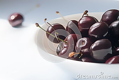 sweet cherries on white ceramic bowl Stock Photo