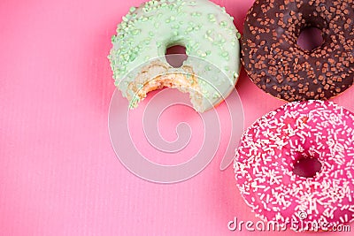 Sweet colorful tasty donuts on pink background. Stock Photo