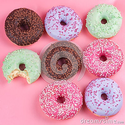 Sweet colorful tasty donuts on pink background. Stock Photo