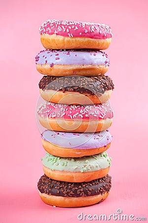 Sweet colorful tasty donuts on pink background. Stock Photo