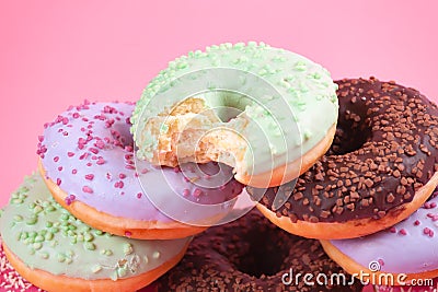 Sweet colorful tasty donuts on pink background. Stock Photo