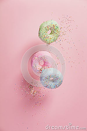 Sweet and colourful doughnuts with sprinkles falling or flying i Stock Photo