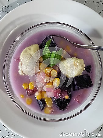 sweet compote made of starchy fruits (purple sweet potato, durian and corn) stewed in coconut milk and sugar Stock Photo