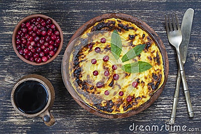 Sweet cottage cheese casserole with raisins and semolina on wooden table. Ceramic bowl with baked cottage cheese casserole , Stock Photo