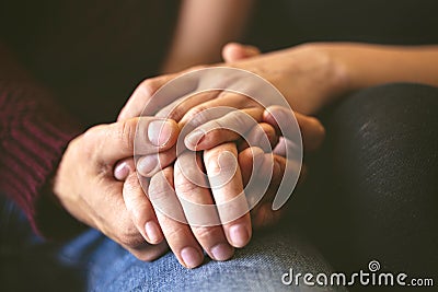 Sweet couple holding hands close up Stock Photo